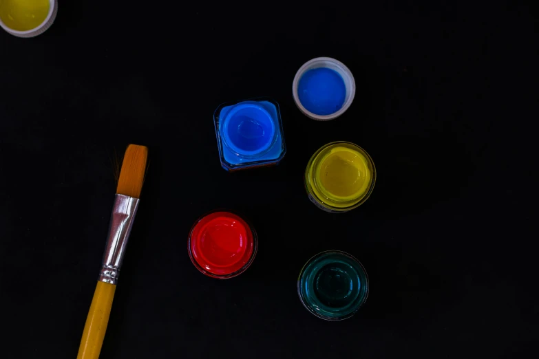 some paint and some paint tubes on top of a table