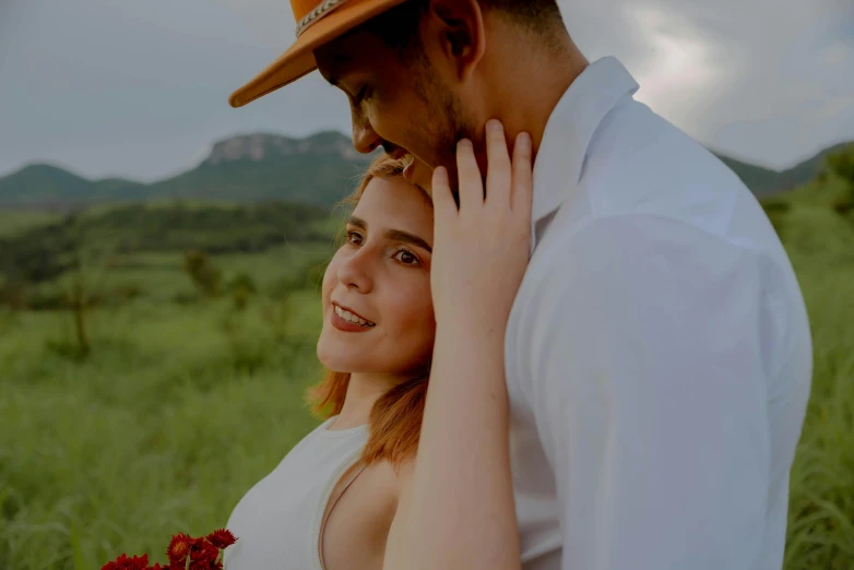 a young lady hugging a man with his arm around her