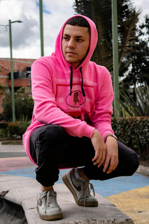 a young man is sitting on a step with his foot in his sneakers