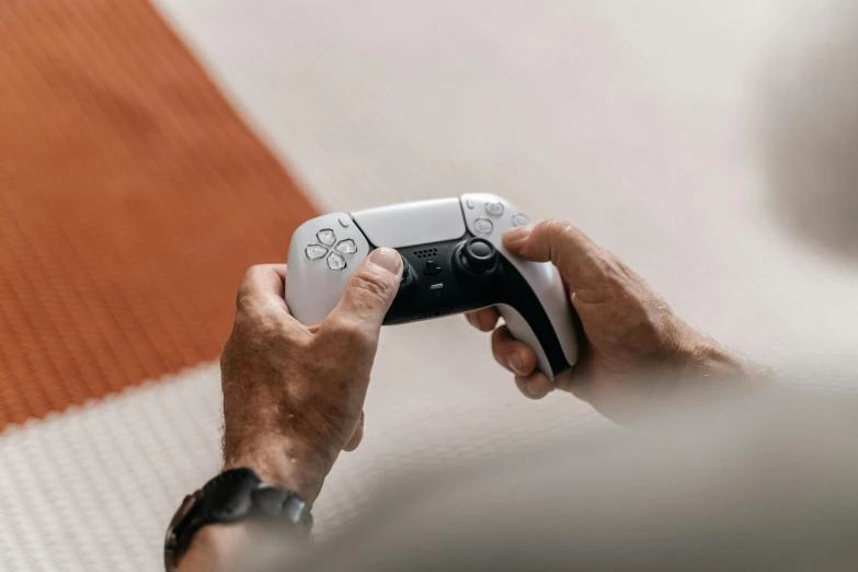 man playing with game on small console controller