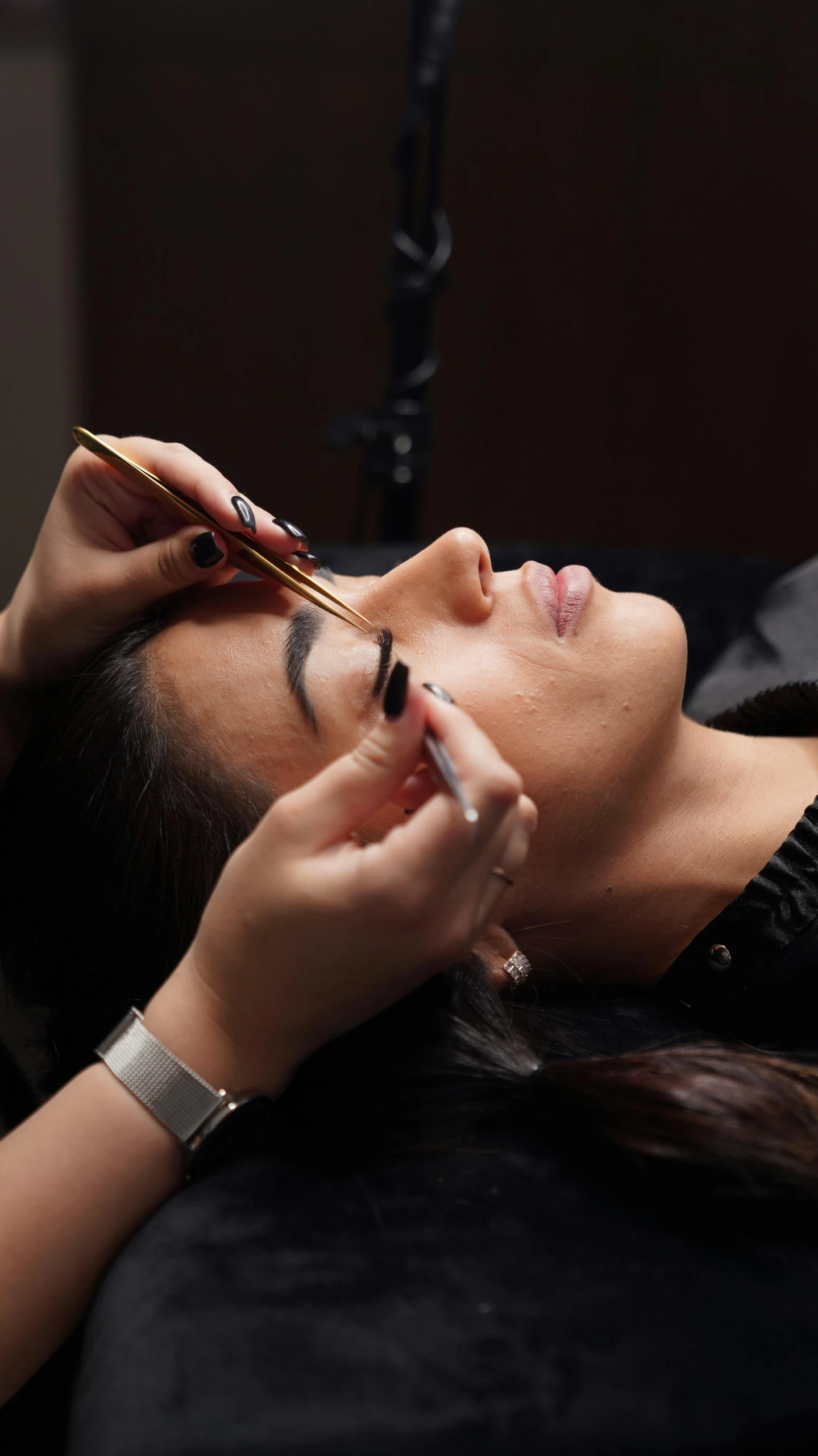 a woman getting her face painted with mascara