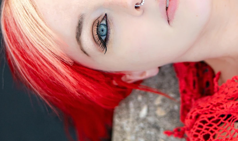 a young lady with red hair and piercings