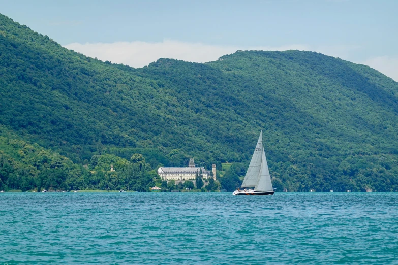 a sailboat is floating along the water