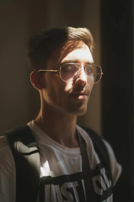 a man with glasses looks to the side