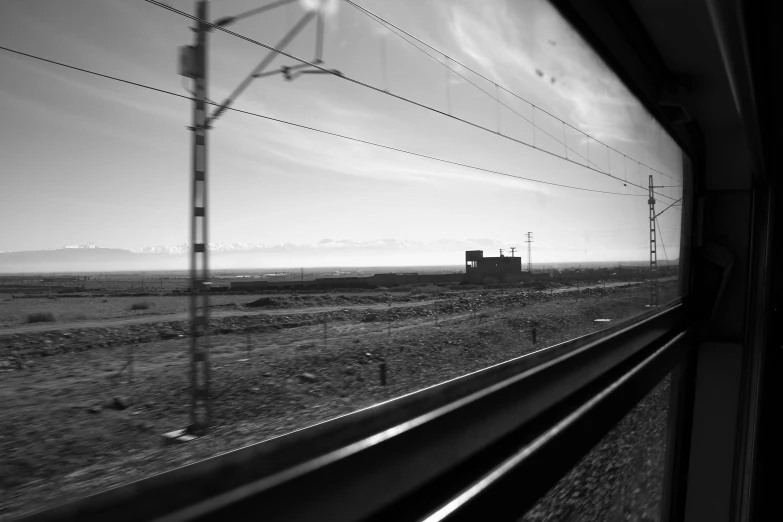 a train travels by some tall brown buildings