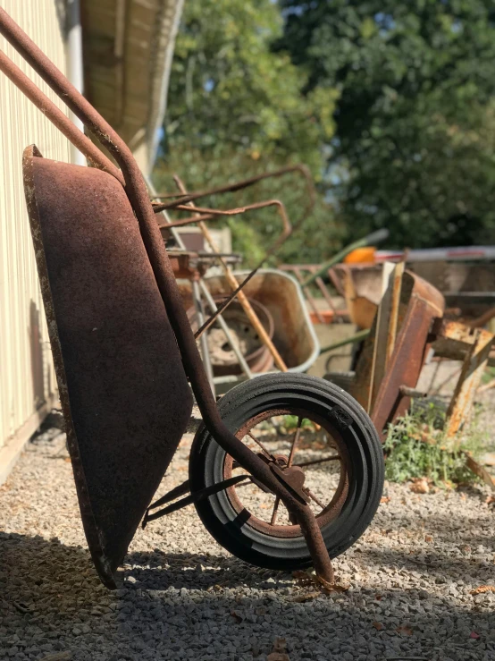 an old rusty bike leaning against a building