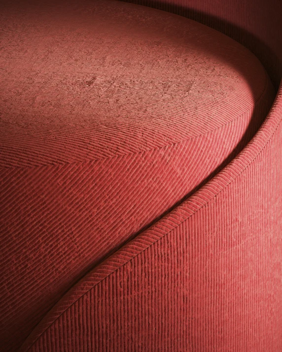 an up close s of red fabric on a piece of furniture