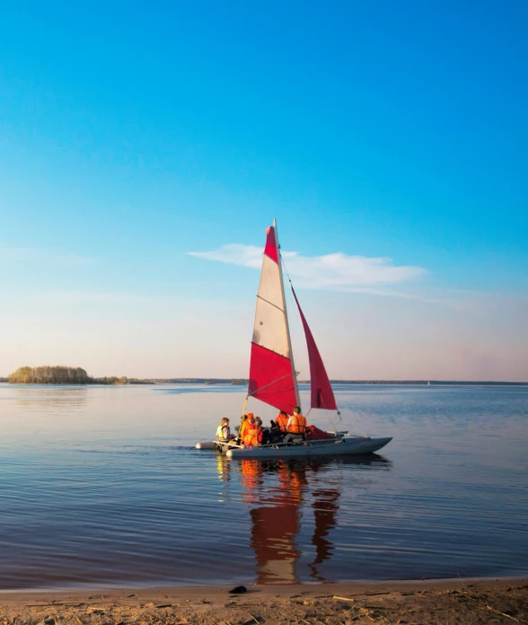 a sail boat with sails sailing in the water