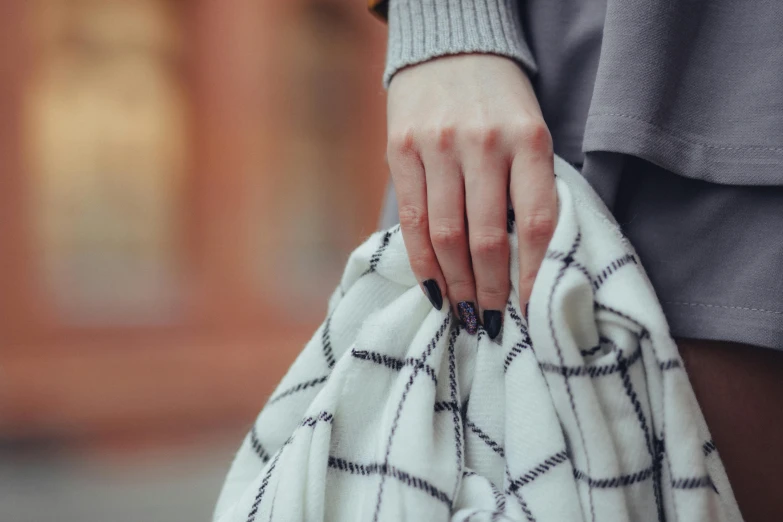 a woman holding her bag close up