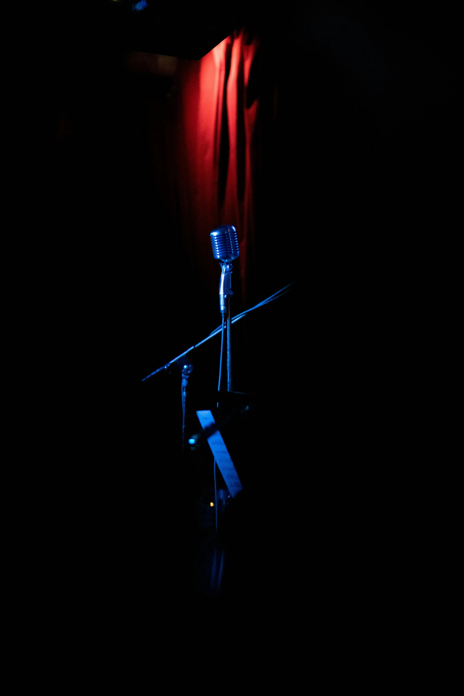 a microphone and a screen in the dark