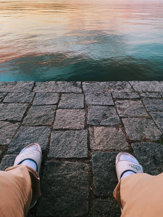 a man is looking at the sky and the water