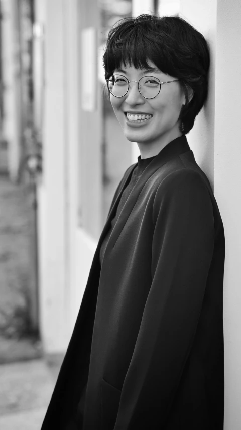 black and white portrait of a young woman wearing glasses