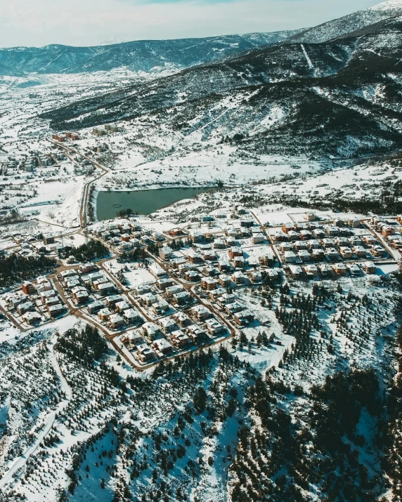 an aerial s of a large village in the mountains