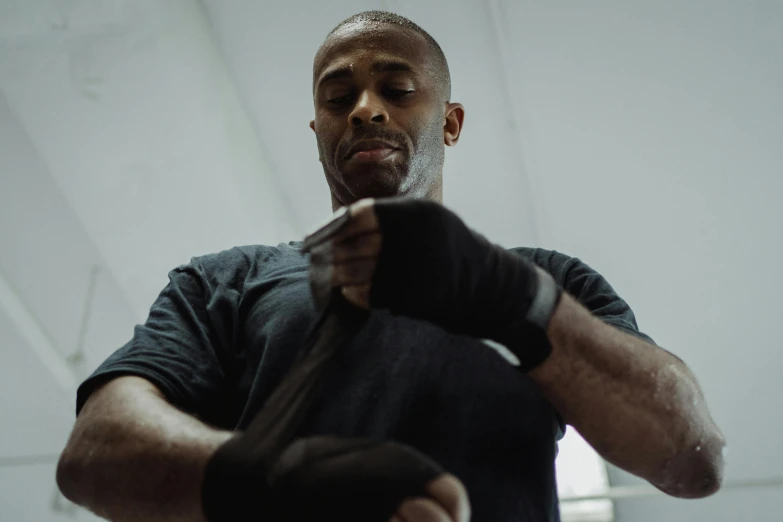 man is working out with gloves in an indoor gym