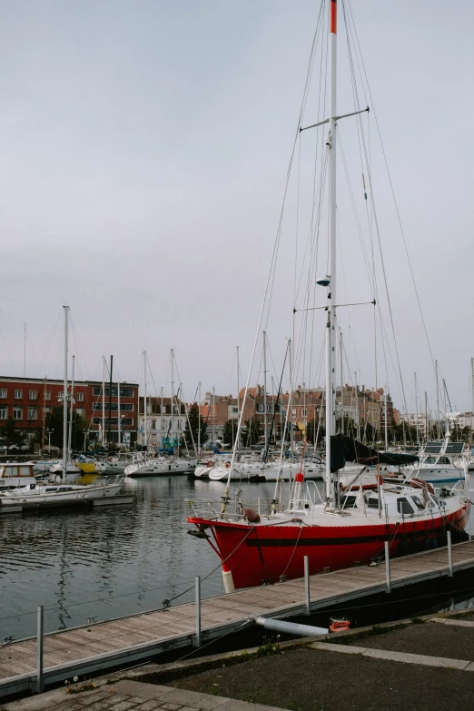 red boat docked at pier on waterfront in city