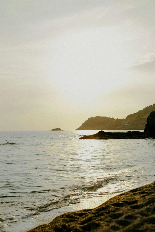 a beach is near an island and ocean