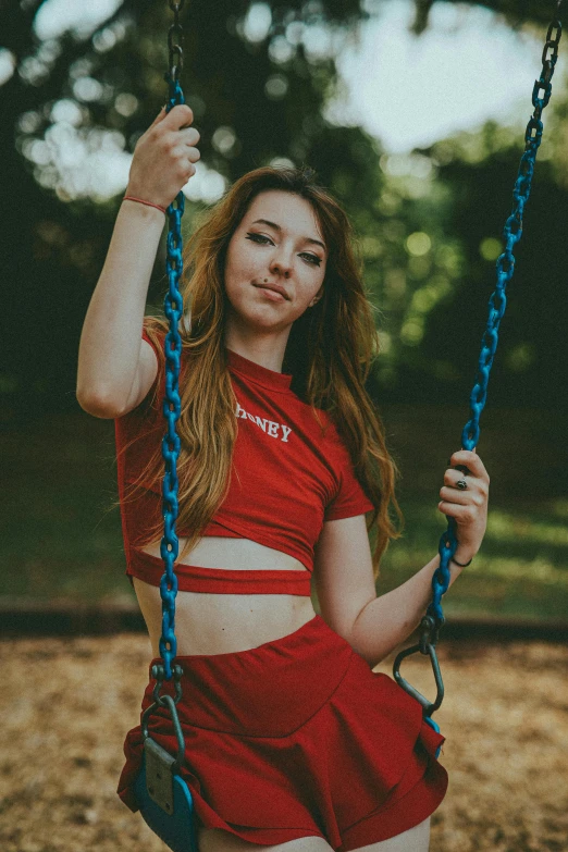 a woman in a red dress and a chain swing