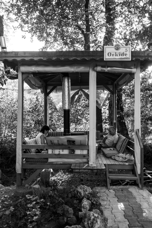 a wooden bench under a wooden gazebo