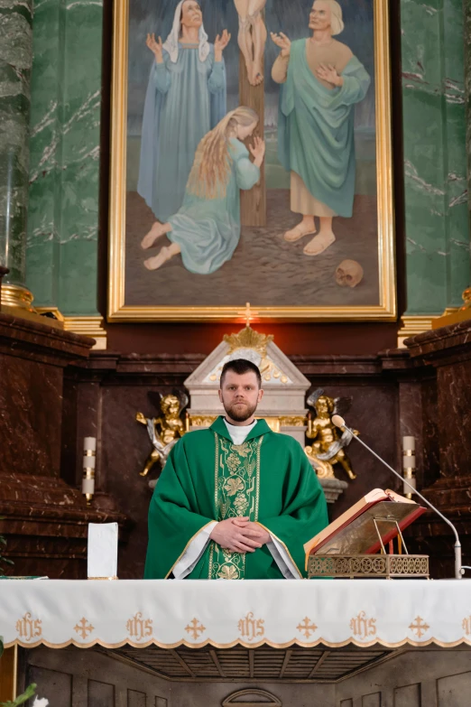 a man sitting in a throne with a cross in front of him