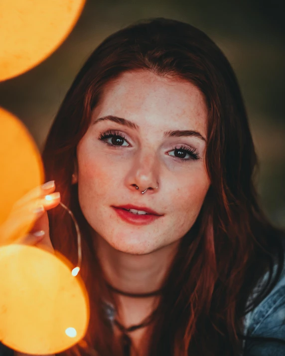 a woman is sitting down with glowing circles behind her