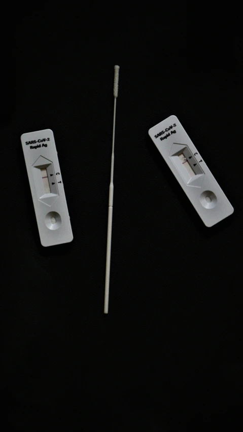 two white matchesticks next to an electrical hazard meter