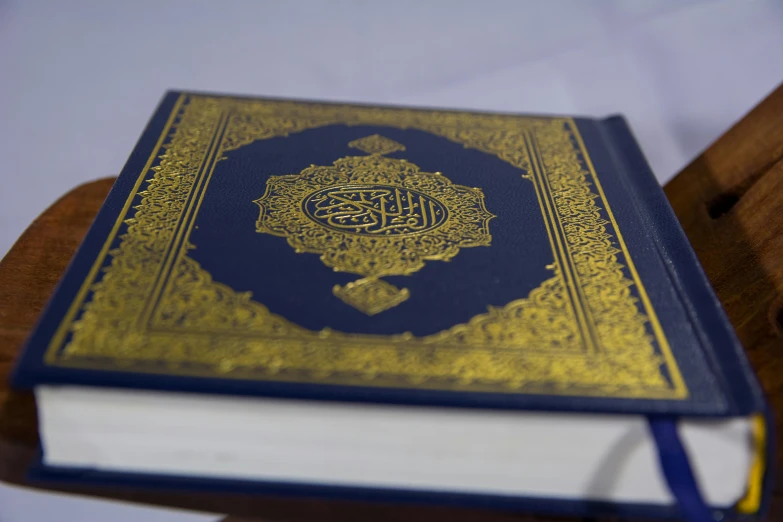 a blue and yellow book with arabic writing