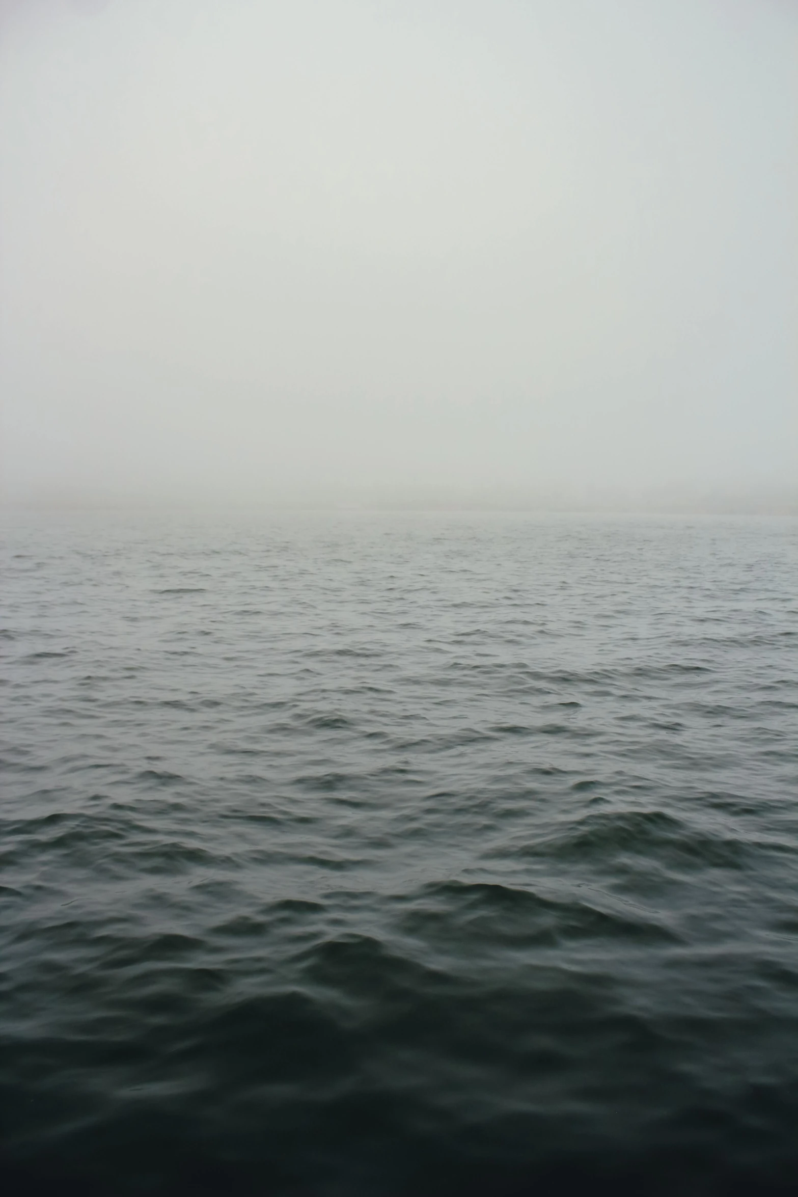 a body of water that is very foggy with soing white