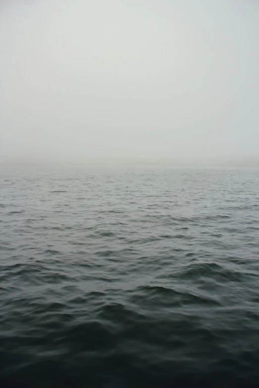 a body of water that is very foggy with soing white