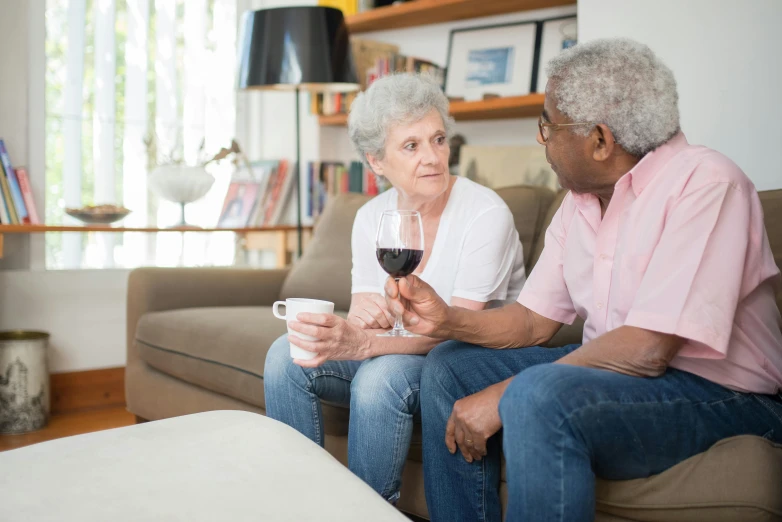 an elderly woman and a younger man sitting on a couch