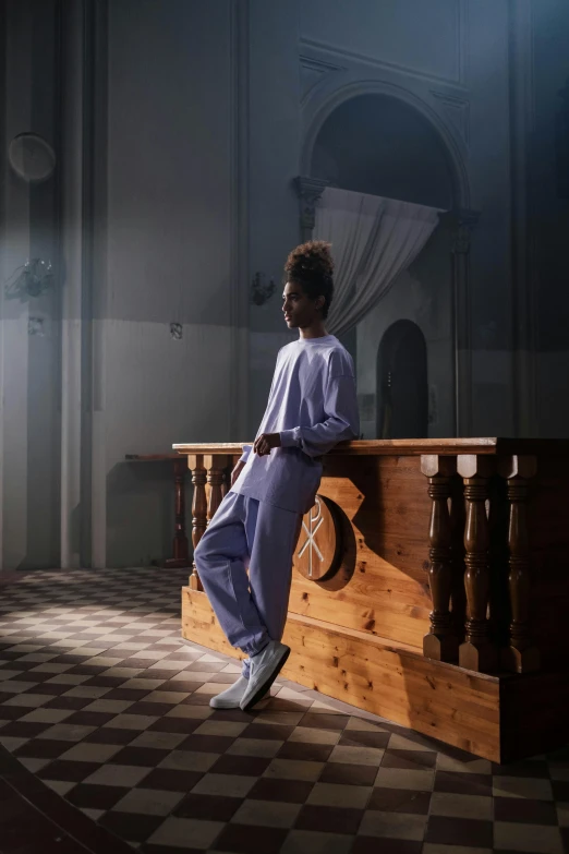 a man is sitting on top of a church pew