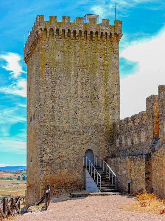 there is a large brick tower building near steps