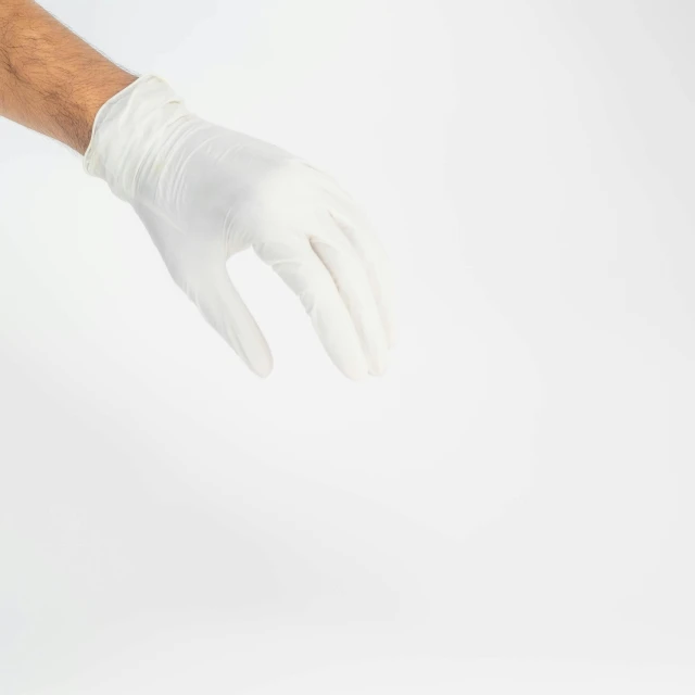 a hand in white gloves reaching out towards the camera