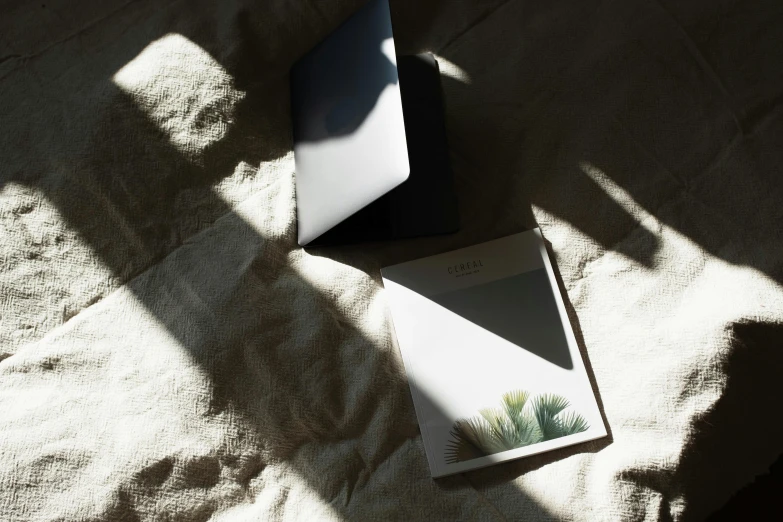 a book about nature is lying on a bed