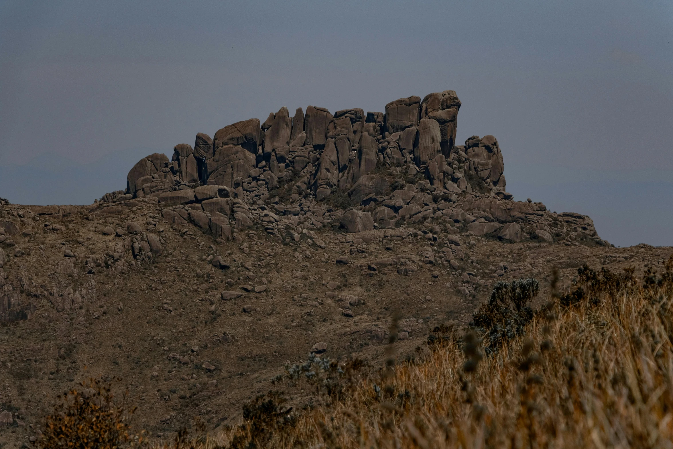 a mountain range with a few rocky cliffs