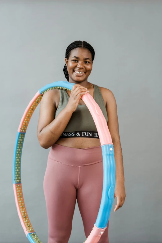 a woman holding a hula hoop