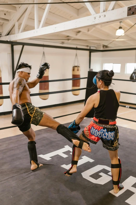 two women are doing kick boxes with each other