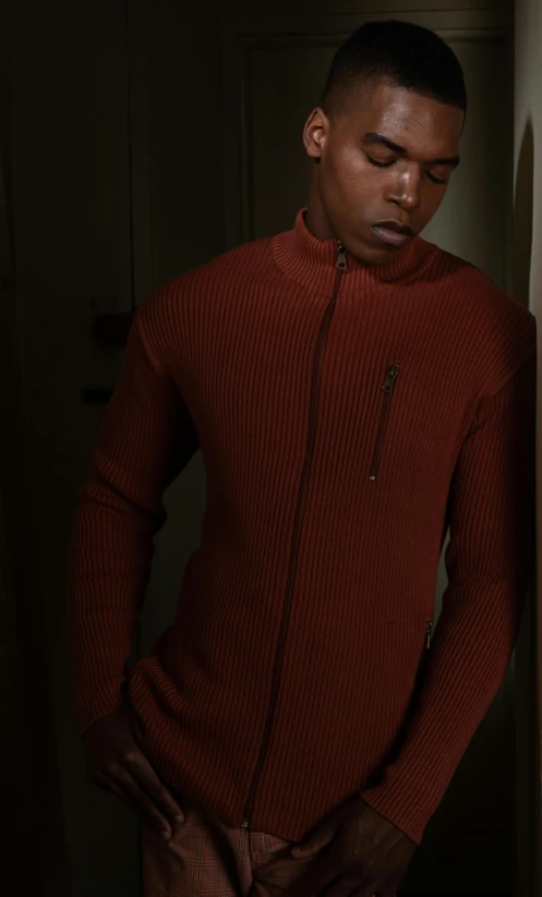 the young man in a sweater is posing for the camera