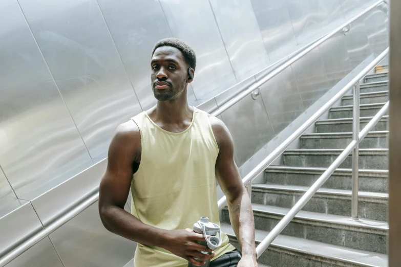 a man holding an object in front of a set of stairs