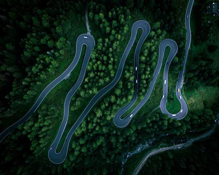 an aerial view of a road that runs through trees