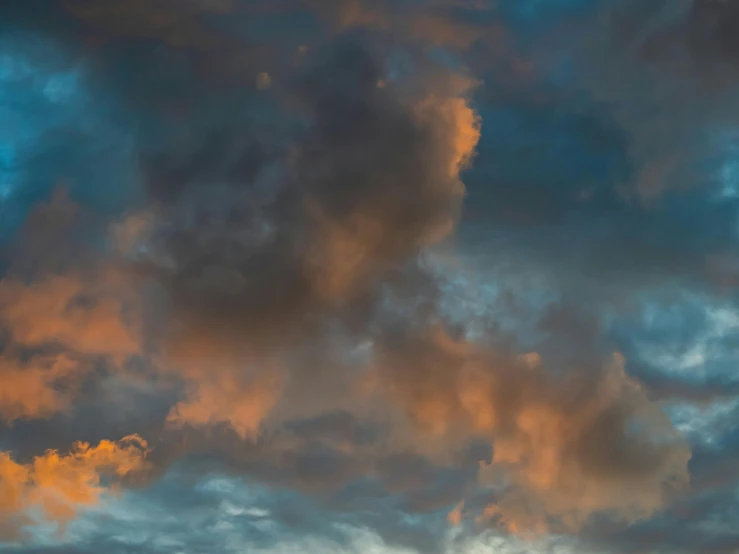 a airplane flying high up in the sky at sunset