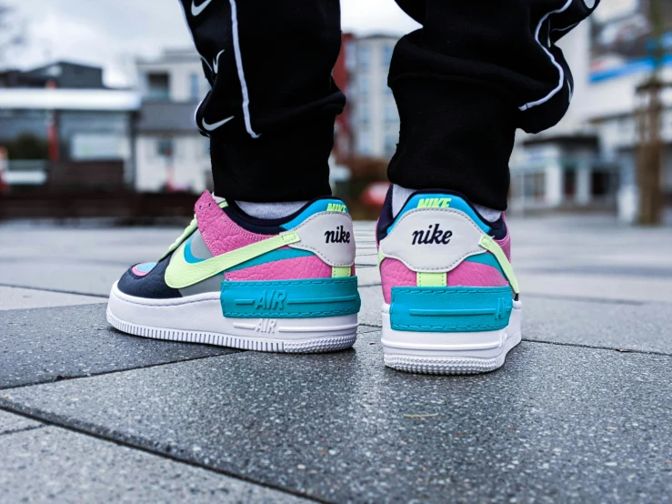 a person wearing sneakers that say nike in neon colors