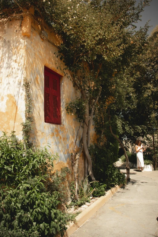 a man standing next to a yellow wall