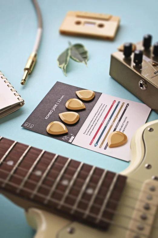 some wooden guitars next to a card and headphones