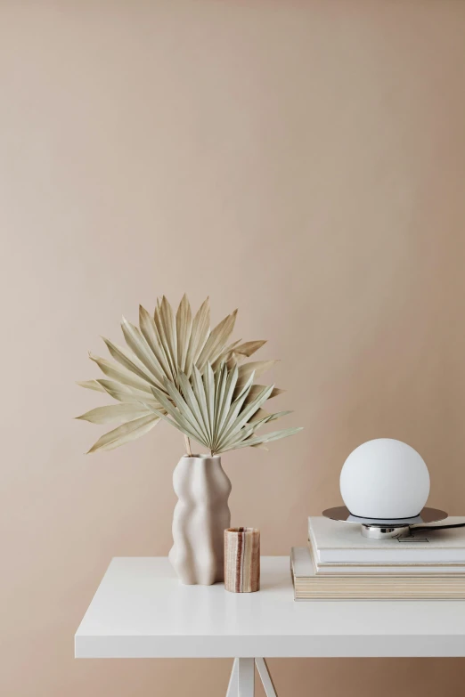 the vase is full of flowers and books next to it