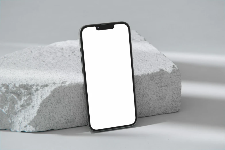 an iphone is sitting on top of some rocks