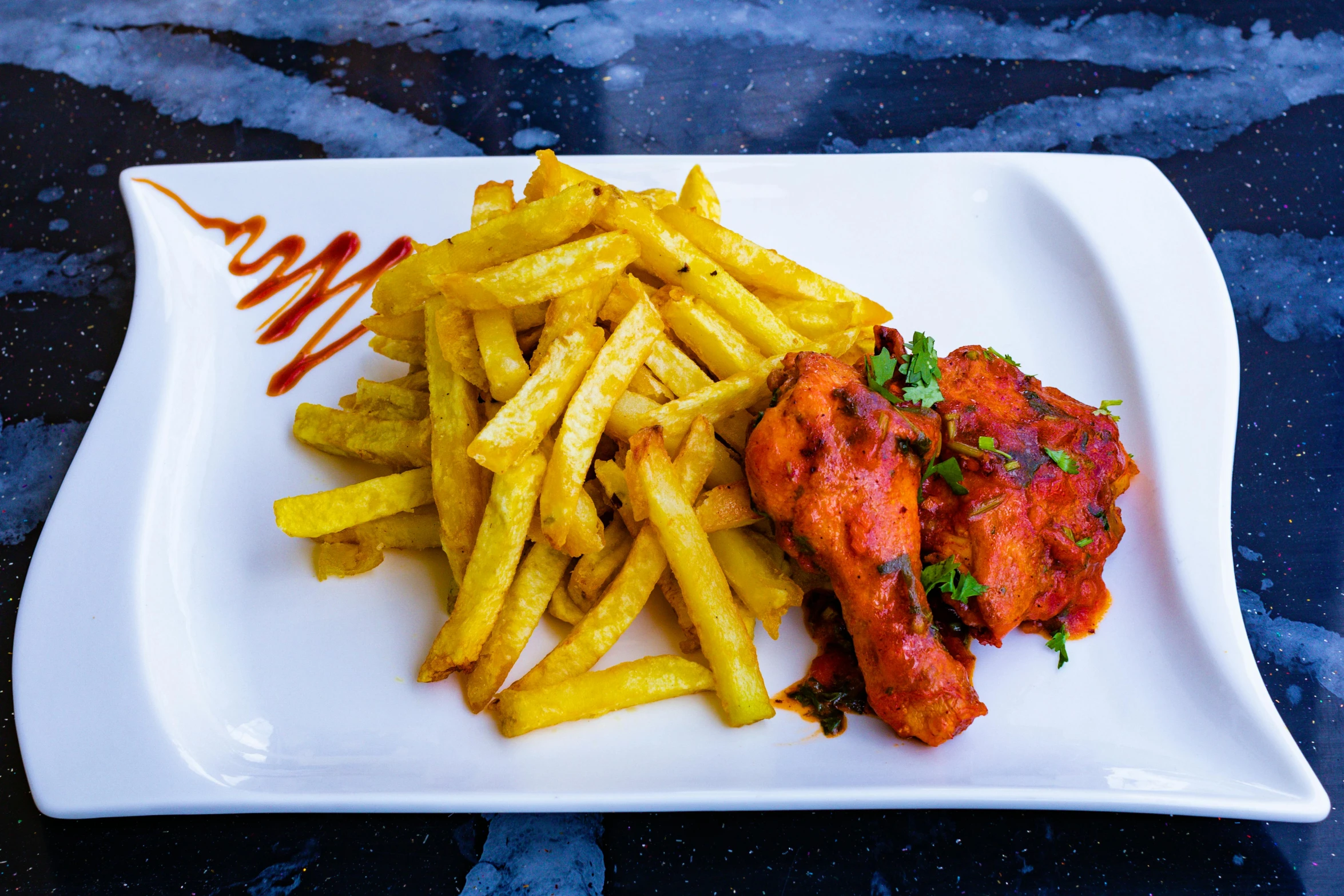 a white square plate with food and french fries