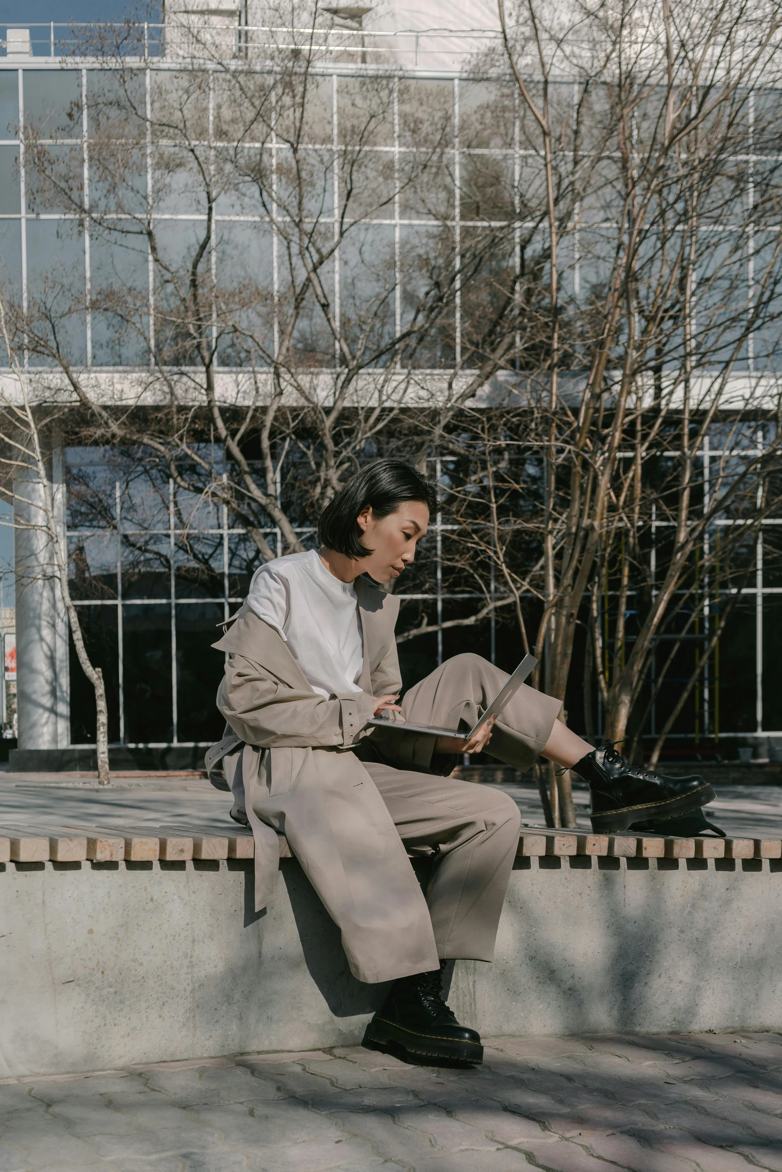 a man sitting on a ledge with his feet propped up