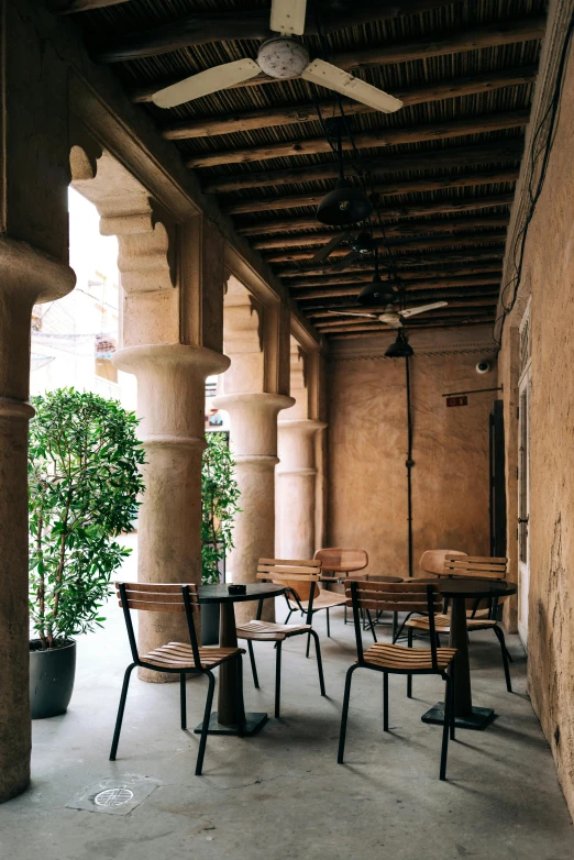 the patio is full of tables and chairs, all empty