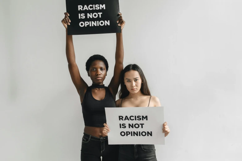 two women holding signs while posing for a po