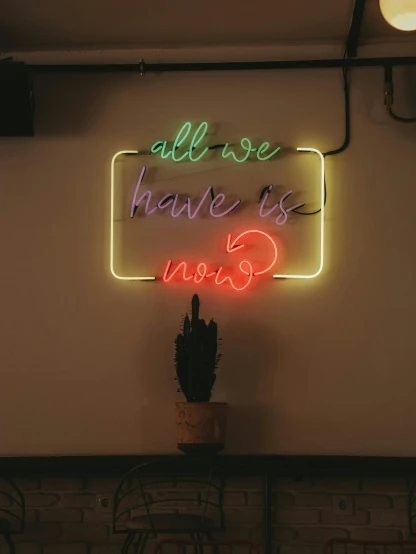 a neon sign that says all we have is now
